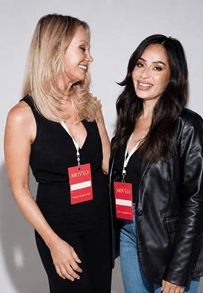 Two women smiling together wearing Movyo All Access badges