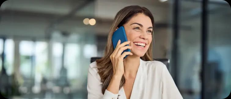 Woman smiling while talking on a smartphone